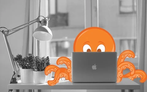 Condo Management Services | Octopus with an Apple MacBook Sitting at a desk